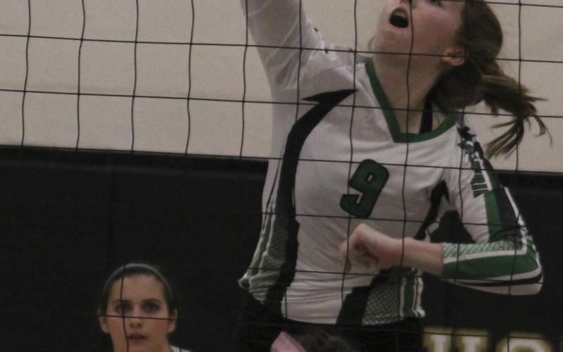 Sophomore Madison Stanley slams the ball past Jim Ned defenders during  UIL Bi-District Playoff Game in Abilene. The Lady Buckaroos fell in five sets.