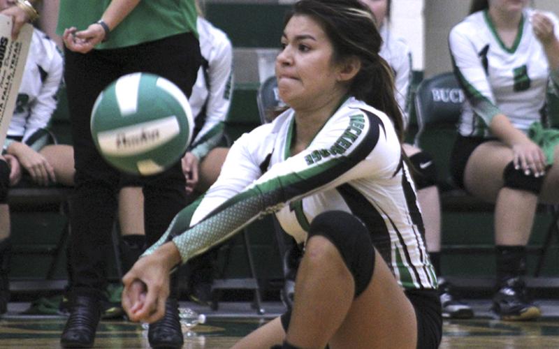 Defensive specialist Aylin Saucedo gets under an opponent's kill.