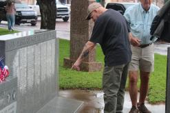 (Archive photo) A veteran points at a name on the Stephens County veterans memorial on the courthouse lawn following last year’s Memorial Day service. New names are inscribed to the monument each year and honored during the annual service which will be held this year at 10 a.m. Monday, May 25. 