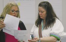 Breckenridge City Secretary shows new resident Caroline Gourley how she can sign up for the text update chain to receive updates from the city on important information and reporting issues.