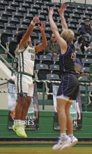 Junior point guard Jaime Cruz, the Buckaroos leading scorer with 11 points, works against Peaster’s Rhett Kelley. Photo/Alex Kielar