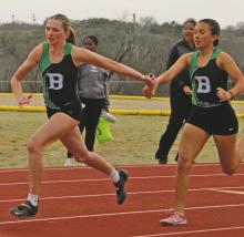 Kamden Tidwell takes the baton from teammate Abbigail Duran during the 4x200 relay in which the Lady Bucks placed second during the Buckaroo Relay Saturday, March 15. Photo/Alex Kielar