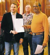 J.D. Wilson, right, stands with Stephens County Judge Michael Roach after commissioners voted their support and endorsement of the former Booker T. Washington School student’s desire to get historical recognition for the once-African American school, along the lines of erecting a historical marker at the site of the school. Photo/Alex Kielar