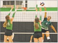 Miley Roberts gets a swing past the Newcastle block during the first set of the Lady Bucks’ 19-25, 26-24, 25-16, 24-26, 15-9 win Tuesday, Aug. 29 over the Lady Cats at Newcastle ISD. Photo/Mike Williams