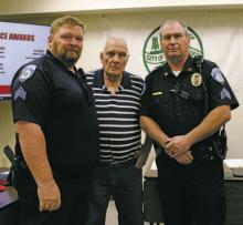 Breckenridge Police Officers Scott Gabriel, right, and Noah Gray, left, were recognized for 15 years of law enforcement service during the City Commissioners meeting Tuesday, Dec. 6. Mayor Bob Sims, center, gave the officers their 15-year pins. Photo/Stevie Watkins