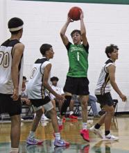 Connor Salazar looks to pass to a teammate in the paint as he looks down the court against Munday as the Bucks finished off their summer basketball league Tuesday, June 24 with matchups against the Moguls and the Hawley Bobcats. Photo/Alex Kielar
