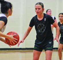 Incoming Lady Bucks freshman Lakyla Bartley guards a player with the ball during a spring league game at Mineral Wells High School. Photo/Alex Kielar