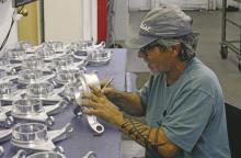 An R.E. Dye Manufacturing employee works on a line of parts that he is tasked with completing. Photo/Alex Kielar