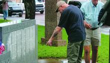 A veteran points at a name on the Stephens County veterans monument in the courthouse lawn following the Memorial Day service Monday, May 26. The process of getting deceased veteran names and inscribing them onto the monument is going through changes, Photo/Alex Kielar