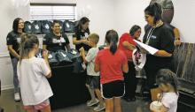 Stephens Memorial Hospital hosted its annual Back to School Bash on Wednesday, Aug. 9. The hospital provided drawstring bags with free school supplies to those who attended. Free snowcones were also available at the event taking place at SMH. Photo/Kaci Funderburg
