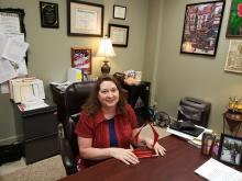 Debbie Karl sits with her award in her office. BA photo by James Norman