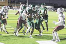 Jaime Cruz drags a defender into the end zone for the game’s first touchdown on Friday, Oct. 27. The Buckaroos defeated Bowie 28-21. Photo/Mike Williams