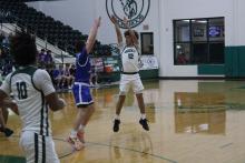 (Photo/Alex Kielar) Ryan Waller attempts a three-pointer from the top of the key over an Abilene Christian defender during the second half of the Buckaroos’ opening game of pool play for the Buckaroo Shoot Out tournament Thursday, Dec. 4. 