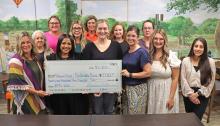 (THOMAS WALLNER | THE GRAHAM LEADER) Members of Virginia’s House accepted a $21,500 check from the Run for the Children board Tuesday, July 1 from proceeds raised from the run and auction. This year’s event celebrated 20 years in Graham, with over $230,000 raised since its establishment.
