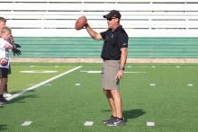 (File Photo) Buckaroos head football coach and athletic director Casey Pearce coaches kids up during the football camp in 2023. Pearce was recently named as the 2025-26 Region 2 director for the Texas High School Coaches Association Board of Directors. 