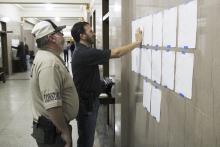 Stephens County Constable Wayne McMullen (left) and Stephens County Judge Michael Roach (right) look at early voting and absentee voting results for the Stephens County Republican and Democratic primary elections at the Stephens County Courthouse. Photo/Mike Williams