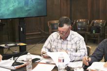 Stephens County Precinct 3 Commissioner Will Warren looks over a draft agreement for a tax abatement for La Casa Wind, LLC during a public hearing and vote Monday, March 11. Photo/Mike Williams