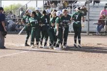 The Lady Bucks celebrate a home run hit by Joni Jackson in the second inning of the Lady Bucks' win at Dublin. Photo/Mike Williams