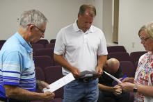 (Photo/Alex Kielar) Paul Lippe, left, and Ty Bartoskewitz, center, are sworn in onto the Breckenridge ISD board of trustees by PEIMS Coordinator Lisa Wright after they were appointed to the vacant place 3 and place 4 seats on the board Monday, July 14. 