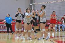 (Photo/Alex Kielar) Before lining up for the opening serve against the Albany Lady Lions, the Lady Bucks high five Friday, Aug. 8 as they got their first taste of competition in the first scrimmage leading into the 2025 season. 