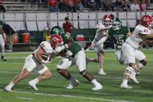 (Photo/Alex Kielar) Christian Flores tackles Cole Chittum behind the line of scrimmage in the Buckaroos’ 49-7 loss to Jim Ned, in which they struggled to contain the Indians’ offense Friday, Oct. 17. 