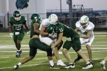 (Photo/Alex Kielar) Joseph Juneau (7) and Hunter Davis (11) gang tackle the Wall ball carrier behind the line of scrimmage for a tackle for loss Thursday, Aug. 21 during the Bucks’ scrimmage at Wall. 