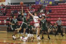 (Photo/Alex Kielar) Conor Salazar goes up for a shot in the paint over one defender after leaving another in the dust as he drives to the basket Friday, Dec. 19 in the Bucks’ district opener. 