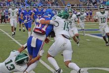 (Photo/Alex Kielar) Sophomores Tucker Baugh (15) and Ryan Waller (13) work together on dragging the Childress ball carrier down in the first half of the Bucks’ 21-14 loss to the Bobcats on the road Friday, Sept. 5. 