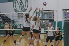 (Photo/Alex Kielar) A pair of Lady Bucks’ front line players, Paisley Thibodeux, left, and Ava Russell, work defensively at the net as they look to block a hit by Comanche during their district opener Tuesday, Sept. 9. 