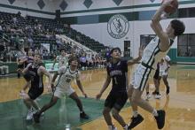 (Photo/Alex Kielar) Conor Salazar pulls up for a midrange shot attempt over a Roscoe defender Friday, Nov. 21, as the Buckaroos opened their season with a 46-42 win. 