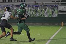 (Photo/Alex Kielar) Jaimie Cruz beats Corbin Harrison to run into the end zone for an 18-yard touchdown run in the second half as the Bucks scored their first touchdown of the evening Friday, Sept. 12, against Cisco. A Josiah Acosta extra point gave the Bucks the lead before they fell 18-14. 