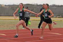 (File Photo/Alex Kielar) Kamden Tidwell takes the baton from Abbigail Duran during last track season’s girls 4x200 of the Buckaroo Relays at the track behind South Elementary. The track is set to be resurfaced over the next couple of months after the BISD school board approved the construction bid Monday, Oct. 13. 