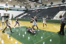 The Buckaroos’ Douglas White fights for the ball un- der the basket during the third quarter of the Bucks’ 56-55 season-opening win Friday, Nov. 17 against Merkel. White finished the game with 11 points. Photo/Mike Williams