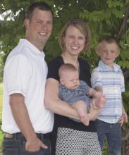 Dr. Kelli Knight-Windsor (center) poses for a photo with  her husband Chris and sons Cason and Caleb.