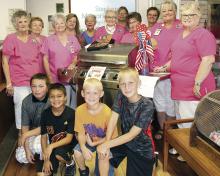 Area children and the Stephens Memorial Hospital Auxiliary pose for a photo during an event in June.