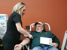 Samantha Kruse with Carter Bloodcare sets up Tom Claybrook to donate a pint of blood. Clayborn has donated at least 16 times with Carter. Kruse has worked for Carter for about two years. BA photo by James Norman