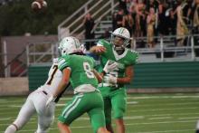 Kevin Franco throws a pass under pressure. Franco was taken out at quarterback late game and replaced by Owen Woodward. Woodward and Franco both threw one interception each. BA photo by James Norman