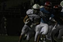 Senior Lonnie Hinson runs for a long gain against Hirschi.