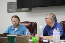 Tim Seymore (right) talks to Board President Graham Reaugh at the BISD school board's May meeting. BA photo by James Norman