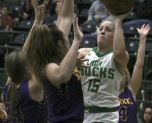 Swarmed by Merkel defenders, Breckenridge senior Carley Tennison puts in a basket Monday night. Tennison led the Lady Bucks in scoring with 11 points.