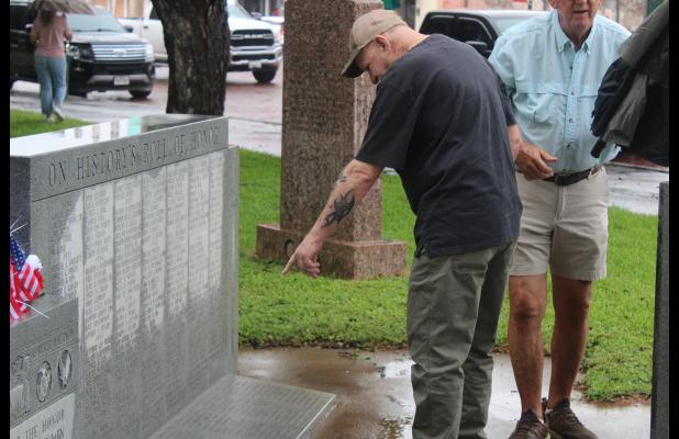 (Archive photo) A veteran points at a name on the Stephens County veterans memorial on the courthouse lawn following last year’s Memorial Day service. New names are inscribed to the monument each year and honored during the annual service which will be held this year at 10 a.m. Monday, May 25. 